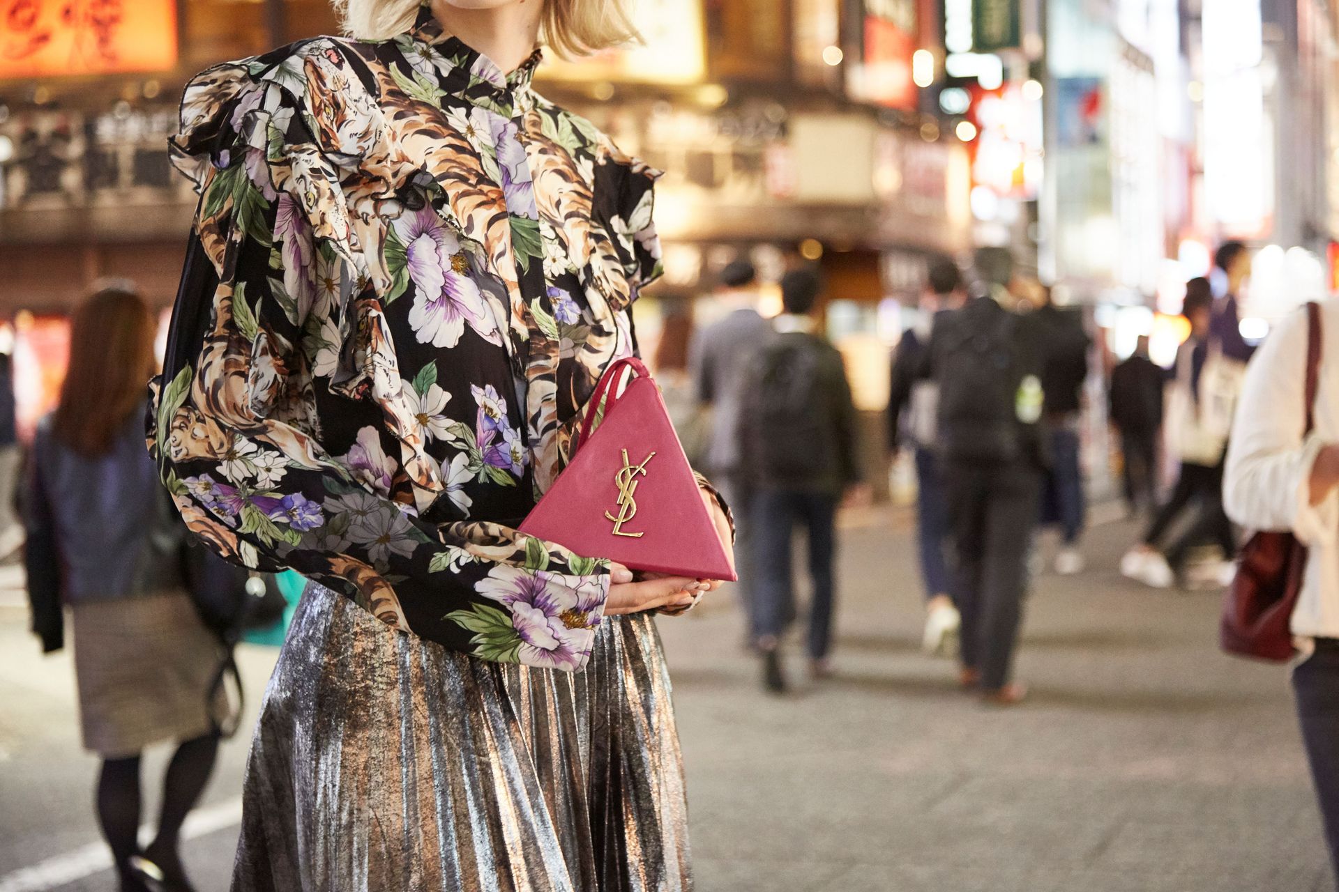 Woman holding saint laurent handbag in street
